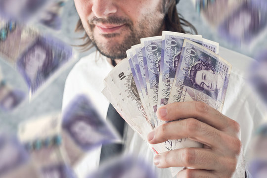 Businessman Holding British Pounds Money, Bnknotes Falling From