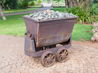 Rusted old mining carriages filled with stones