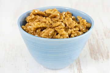walnut in blue bowl on white background