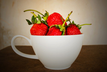 Strawberry in cup on white