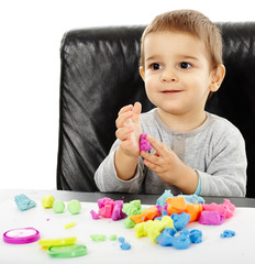 Little boy playing with plasticine