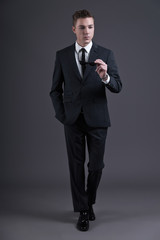 Retro fifties fashion young businessman holding black sunglasses