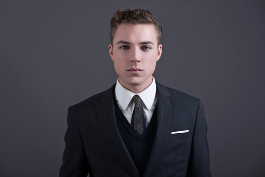 Retro fifties fashion young businessman wearing dark suit and ti