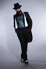 Retro hipster 1900 fashion man in suit with black hair and beard
