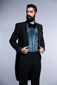 Retro hipster 1900 fashion man in suit with black hair and beard