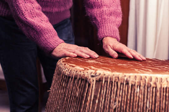 Old woman playing bongo drums