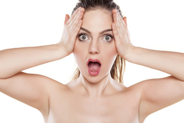 shocked beautiful girl posing on a white background