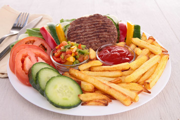 plate of beef, french fries and vegetables