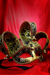 Vintage venetian carnival mask on velvet background