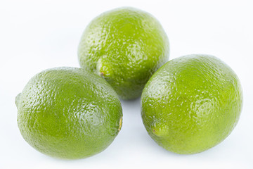 Three limes on white background