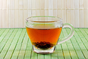 cup of tea in front of a straw mat