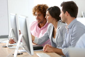 Young business people in office working together