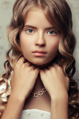 Naklejka premium Portrait of a little princess with long wavy glossy hair