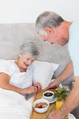 Foto op Canvas Senior man giving breakfast tray to wife in bed © WavebreakmediaMicro