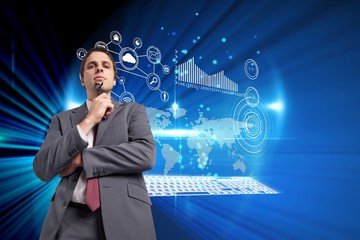 Composite image of thinking businessman holding his glasses