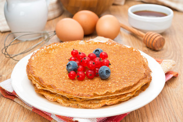 crepes with fresh berries and ingredients for baking, horizontal