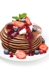 pancakes with cream and fresh berries, close-up, isolated