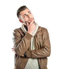 Young man thinking over white background