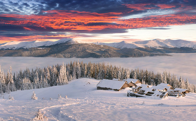 Panorama of the foggy winter sunrise in the mountains