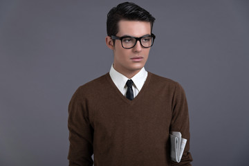 Obraz premium Retro fifties fashion man with dark grease hair. Wearing brown s