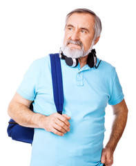 An old man with a headphones looking away