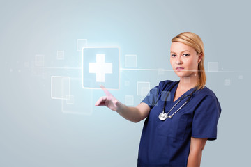 Young nurse pressing modern medical type of buttons