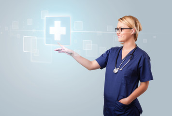 Young nurse pressing modern medical type of buttons