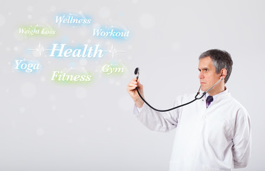 Clinical doctor pointing to health and fitness collection of wor