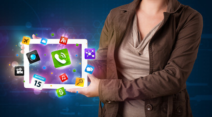 Lady holding a tablet with modern colorful apps and icons