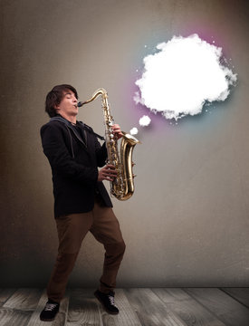 Young man playing on saxophone with copy space in white cloud