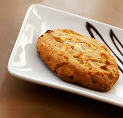 Cookie served on a plate with chocolate dressing