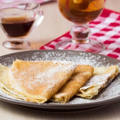 Thin sweet pancakes with powdered sugar for Shrovetide