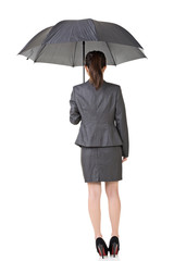 Asian business woman is holding umbrella