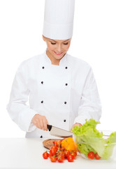 smiling female chef chopping vagetables