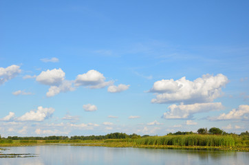 Obraz na płótnie Canvas Summer sky over the calm lake.