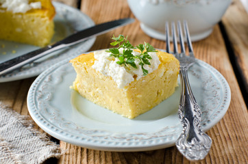 Cheese pie on a plate on a wooden table