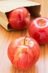 Fresh red apples with paper bag