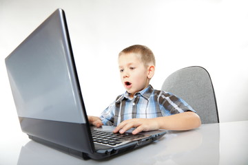 Computer addiction emotional boy with laptop