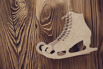 Pair of carton figure skates over wooden background