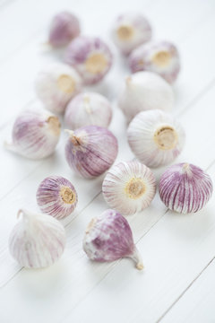 Chinese solo garlic over white wooden background, vertical shot