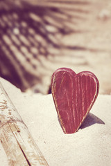 Fototapeta premium Rustic red heart on the sand beach. honeymoon, wedding vovayion