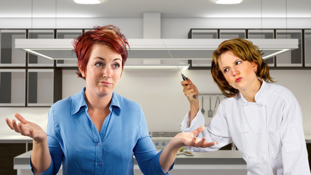 young waitress and chef fighting in a kitchen