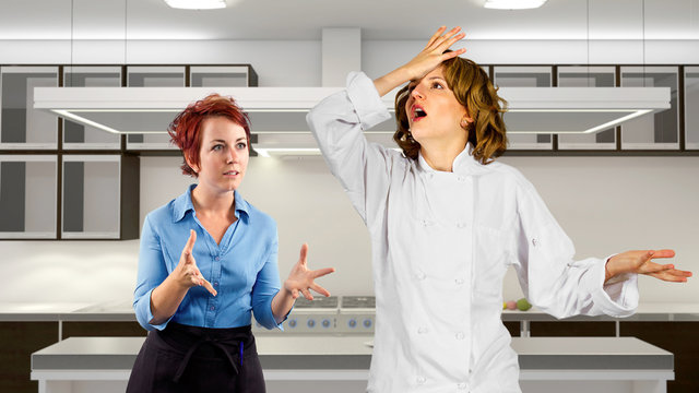 young waitress and chef fighting in a kitchen