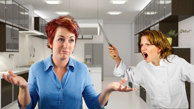young waitress and chef fighting in a kitchen