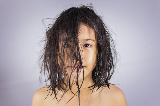 Little girl with wet hair .