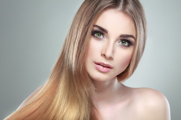 Fototapeta premium Beautiful girl on a light-grey background, emotions, cosmetics
