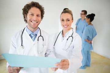 Fototapeta premium Happy doctors holding file