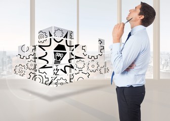 Fototapeta premium Composite image of thinking businessman holding pen