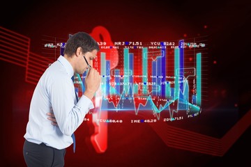 Composite image of thinking businessman holding pen