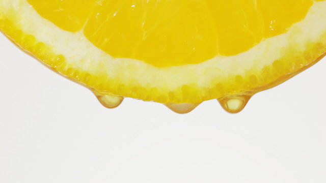 Squeeze out juice. Drops of juice of a citrus.